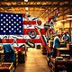 A shopping cart filled with American-made products, showcasing the importance of buying U.S. goods to support jobs, the economy, and the environment.