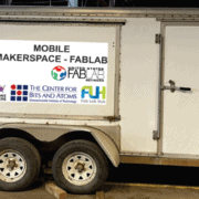 Mobile Makerspace trailer with logos of Forest CNC, United States Fab Lab Network, Fab Foundation, Fab Nation, and MIT Bits and Atoms.